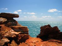 Red rocks on the Broome coast contrasted against the waters of the Indian Ocean.