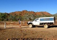 Opening one of many gates on Australian Outback road Opening one of many gates on Australian Outback road
